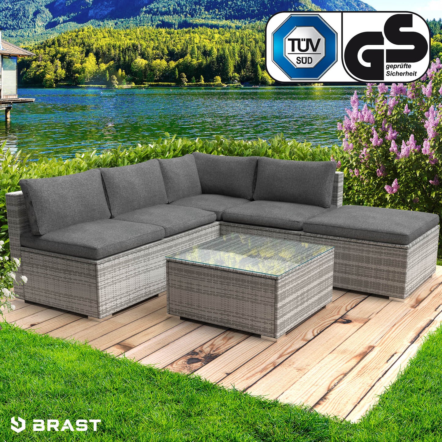 Graues Polyrattan Lounge Gartenmöbel Set mit grauen Kissen und Glas-Tischplatte als Loungemöbel für den Außenbereich.
