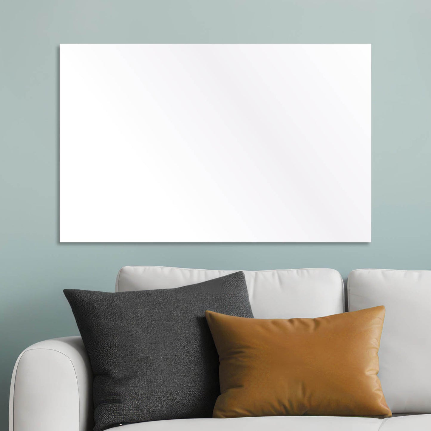 Weiße rechteckige Infrarotheizung an hellblauer Wand über grauem Sofa mit zwei Kissen.